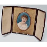 MINIATURE - A late 19th/early 20th century oval miniature of a young lady in a yellow metal frame,