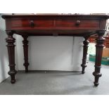 A Victorian mahogany two drawer side table - Two short frieze drawers and standing on turned legs,