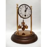 Anniversary clock under dome - An early to mid 20th century brass timepiece under a glass dome