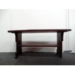 Cornish oak bench - A two tier bench, the top having carved decoration of pike and ecclesiastical