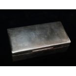 A silver cigarette box, cedar wood lined, bears initials to top G.F.H. and 01.12.1930, engine turned