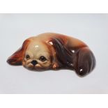 W.R. Midwinter Ltd - A recumbent Pekingese dog, width 11.5cm.