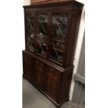 A mahogany three sectional astragal glazed bookcase - With three adjustable height shelves over