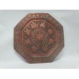 A Persian octagonal repousse copper tray having an eight pointed star to the centre, with fish,