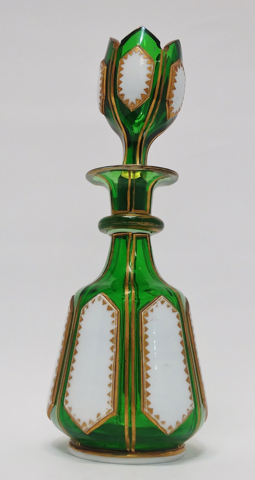 Bohemian Glass - A green glass gilt and white enamel small decanter and stopper, height 21cm.