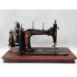 Sewing machine - A Pfaff hand cranked black and gilt painted machine 'B' in a walnut square case,