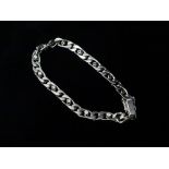 A modern 18ct white gold curb link bracelet set with thirteen circular cut diamonds, each weighing