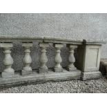A section of reconstituted stone garden wall to include balustrades, height 65.5cm, total width