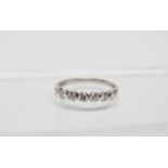 A 18ct white gold and diamond ring - A white gold ring set seven diamonds totalling 0.56ct