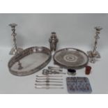 A quantity of silver plate, to include two trays, a pair of Rococo style candlesticks, height 25.