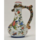 Faience - A signed puzzle jug with polychrome decoration depicting a cornucopia, insects and