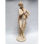 Lady statue - A resin statue of a classical lady in diaphanous dress holding a garland of flowers,