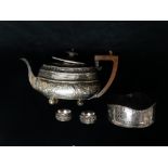A silver plated teapot with repousse decoration, the cartouches marked 'MEEATT MEER EAST INDIES