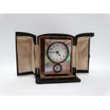 Miniature bedside alarm clock - A mother of pearl cased twin dial clock, in a fitted green leather