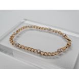 A 15ct gold and diamond bracelet - A 15ct gold curb link bracelet set seven brilliant cut diamonds