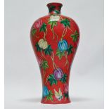 A Chinese Meiping vase, the dark rose pink coloured body with coiled fern relief decoration, the