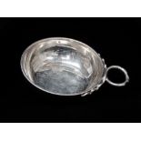 A French silver tastevin, strike mark to handle and inner rim, height 2.5cm, diameter 8.3cm,