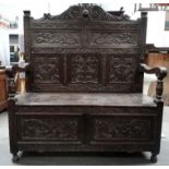 Victorian carved oak monk's bench - Having open arms and turned supports, height 133cm, width 117cm,