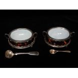 A pair of silver plated and tortoiseshell twin handled salts with ceramic liners, raised on four