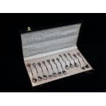 A set of twelve silver plated continental cased teaspoons with floral and foliate ends, each