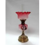 A 19th century 'Superior Duplex' twin burner oil lamp - A brass and vaseline cranberry glass