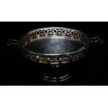 A silver twin handled pedestal bonbon dish with pierced and fretted decoration to sides,