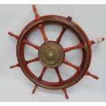 A large teak and brass eight spoke ship's wheel, diameter 120cm.