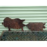 Two steel pig silhouettes, widths 46cm and 55.5cm.