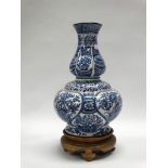 An early 20th century double gourd shaped vase with melon shaped top section with blue and white