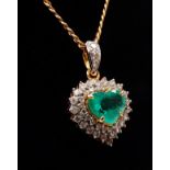 An 18ct gold diamond and emerald heart shaped pendant, width 1.5cm, with 18ct gold chain, chain