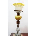 A 19th century oil lamp - With a cut glass base, brass column and yellow flash glass reservoir and