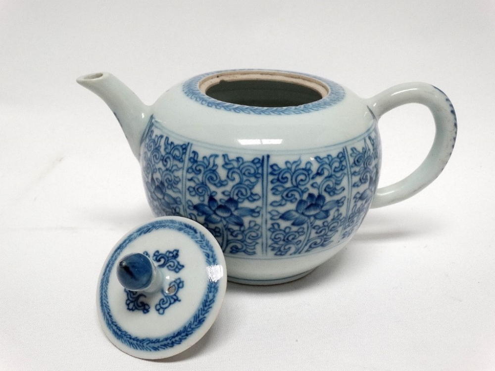 Circa 1900 Chinese lidded teapot - A blue and white peony and scroll decorated teapot, height 11.5.