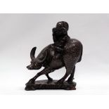 A Chinese carved hardwood, silver wire inlaid group of a boy on a water buffalo, height 27.5cm,