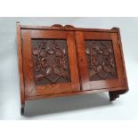 19th century walnut hanging cabinet - A two door carved cabinet, opening to reveal a shelf within,