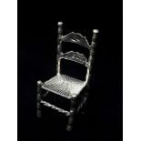 A silver doll's house chair, London 1897, maker's mark for Louis Landsberg, height 4.8cm, weight