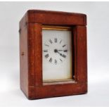 Brass carriage clock - A travelling timepiece with five bevelled glass windows, the leather case