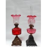 19th century oil lamps - Two glass reservoired oil lamps one ruby, one cranberry glass, both with
