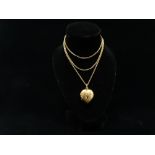 9ct gold chain and locket - A 9ct gold heart shaped front and back locket set a red and white