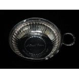 A silver tastevin, engraved to the bowl 'Vivienne A Small Token David Mitchell MP', London 1972,