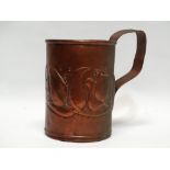 Newlyn Copper - A repousse decorated tankard with floral motifs, maximum height 18cm.