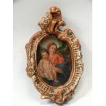 Miniature on panel - An Italian School oil on panel of the Madonna and child in a hand carved gilded