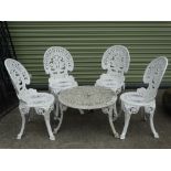 Four white painted Victorian style aluminium garden chairs and a similar low circular garden