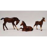 Beswick - Two bay foals (915), largest height 10.8cm, together with a Royal Doulton bay foal, height