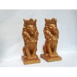 Lion figures - A pair reconstituted stone sejant lions wearing crowns, on squared bases, height 35.
