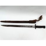 MILITARIA - A circa 1900 Wilkinson of Pall Mall bayonet with leather covered scabbard and webbing