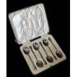 Arts & Crafts - A cased set of six silver coffee spoons with triangular shafts and finials,