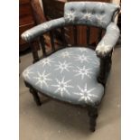 A late Victorian upholstered tub chair - An ebonised overstuffed, button back open armchair with