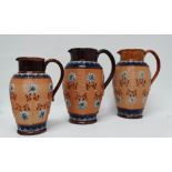 Royal Doulton and Doulton Lambeth England - Three graduated ribbed jugs with relief applied