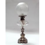A late 19th century silver plate and clear glass oil lamp - A square acanthus form base and column