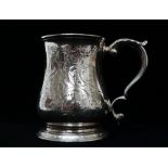 A George II silver tankard with double veloupe handle and vacant cartouche, London 1746, maker's